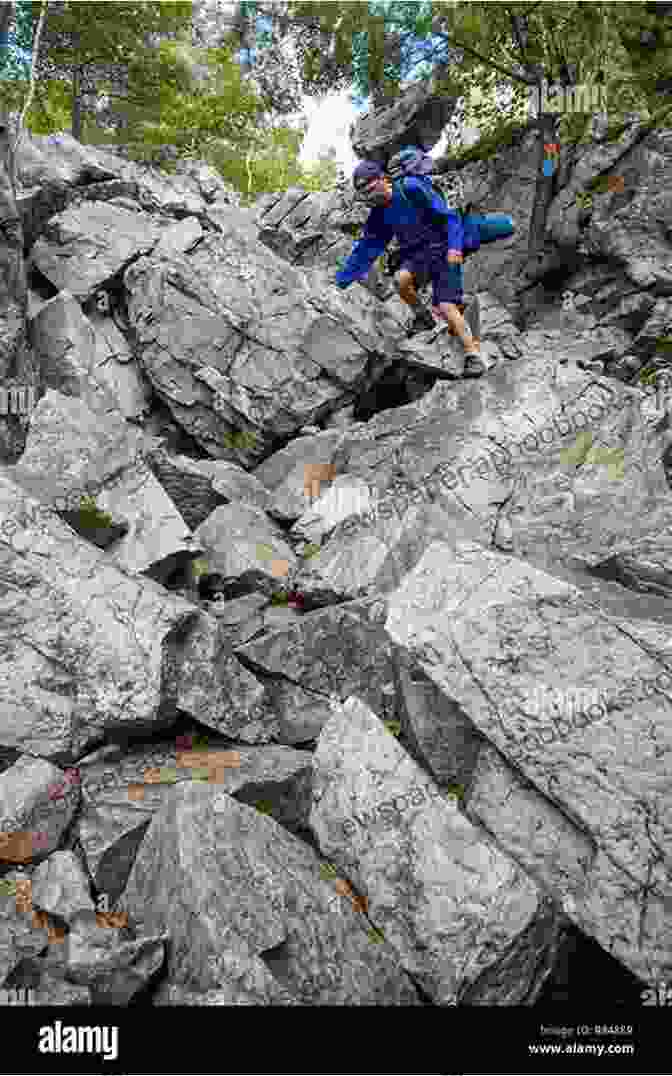 A Hiker Navigates A Rugged Trail In Killarney Provincial Park, Surrounded By Towering Granite Cliffs And Sparkling Lakes. Hiking In Ontario S Multi Regional Trails