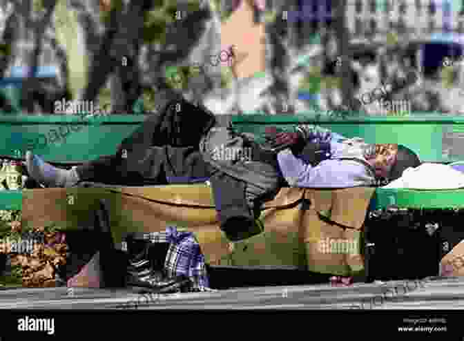 A Homeless Man Sits On A Bench, His Head Resting In His Hands. Homeless DELUXE Giuliano Donati