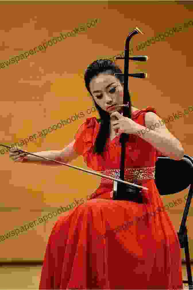 A Person Playing The Erhu, A Two Stringed Chinese Violin How To Play Erhu The Chinese Violin: The Gaohu And Zhonghu